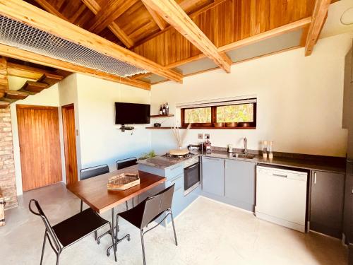 a kitchen with a table and chairs in a room at Swiss Chalet Clarens in Clarens