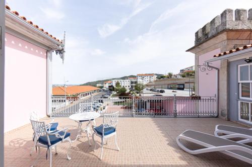 a patio with a table and chairs on a balcony at Palacio Nova Seara 2503 - AL in Armamar