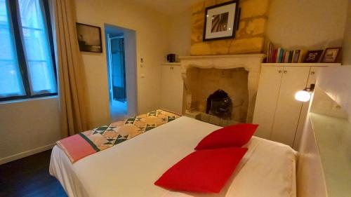 a bedroom with a bed with red pillows on it at Burdigala Homes - Les Apparts de la Course in Bordeaux