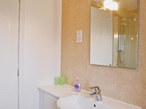 a bathroom with a sink and a mirror at Glenrothay in Aviemore