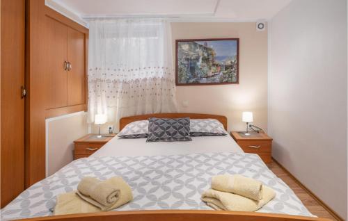 a bedroom with a bed with two towels on it at Awesome Home In Crikvenica With House Sea View in Crikvenica