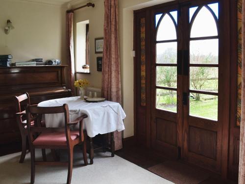 a dining room with a table and a window at Heathfield Lodge in Bransgore