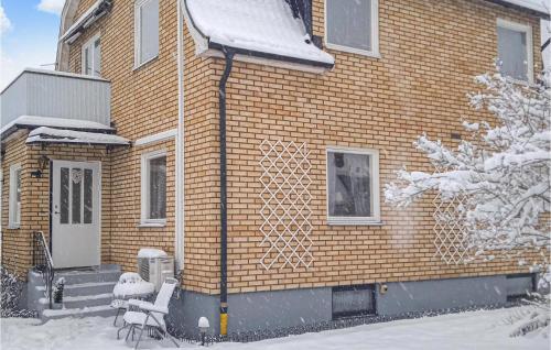 a brick house with snow on the side of it at 2 Bedroom Nice Apartment In Hultsfred in Hultsfred