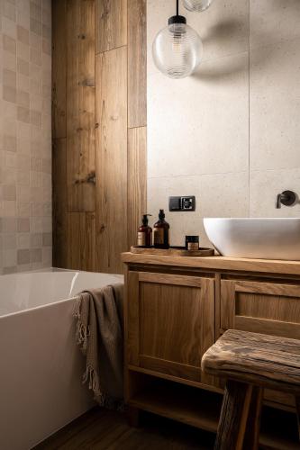 a bathroom with a white tub and a sink at Apartament Malinowa in Zakopane