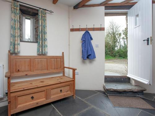 a room with a wooden dresser next to a door at The Roundhouse - Tbe in Crackington Haven