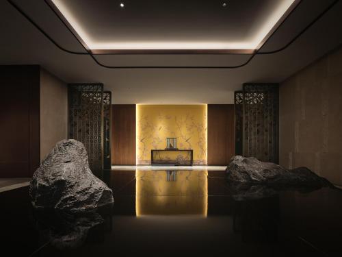 a room with two large rocks and a television at HUALUXE Kunshan Huaqiao by IHG - F1 Racing Preferred Hotel in Kunshan