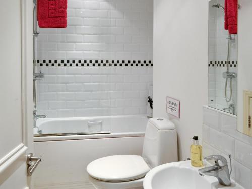 a white bathroom with a toilet and a sink at City 3 in York