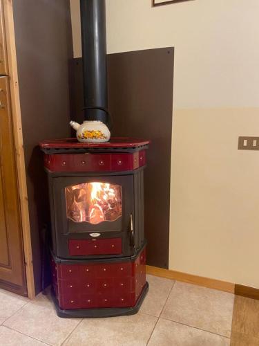 a red stove in the corner of a room at La casetta della nonna in Caramanico Terme