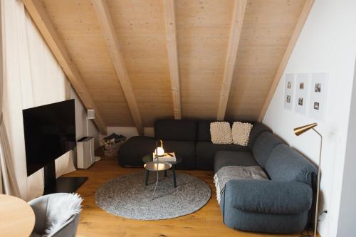 a living room with a couch and a tv at Sunny Retreat Apartment in Kranjska Gora