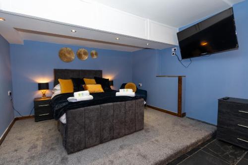 a bedroom with a bed and a flat screen tv at The Ancient Unicorn in Barnard Castle