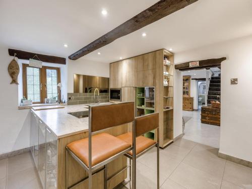 a kitchen with wooden cabinets and a counter with a bar at Ladymoor in Highley