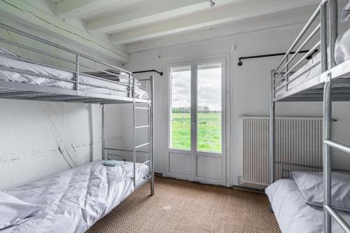 two bunk beds in a room with a window at So Villa Ramenerie 45 - Heated pool - Basket - 1h30 from Paris - 26 beds in Courtemaux