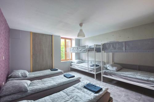 a room with three bunk beds in it at Crazy Villa Margotterie 58 - Heated pool - 2h from Paris - 30p in La Celle-sur-Loire