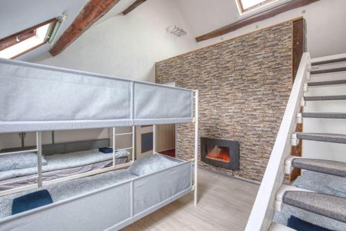 a room with bunk beds and a fireplace at Crazy Villa Margotterie 58 - Heated pool - 2h from Paris - 30p in La Celle-sur-Loire