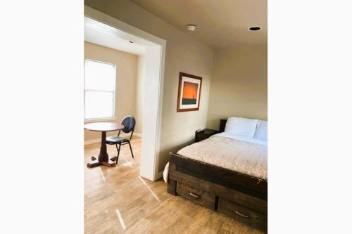a bedroom with a bed and a table at The Resource Inn -Big Lake TX in Big Lake