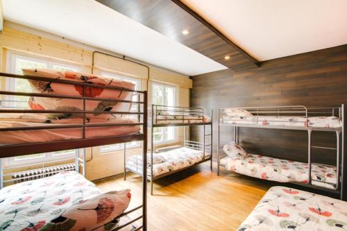 a room with four bunk beds in it at Crazy Villa Radar 89 - Heated pool - Multisports field - 2h Paris - 30p in Saint-Cyr-les-Colons