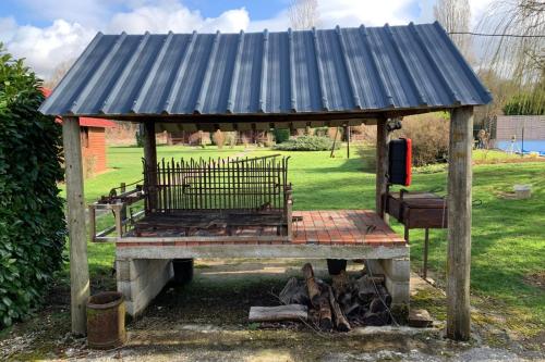 a wooden structure with a blue roof on top at Les Cabanes Parisiennes - Chalets 1h30 from Paris - 62P in Sainte-Geneviève-des-Bois