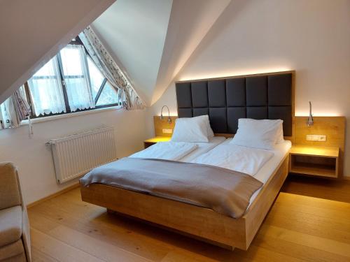 a bedroom with a large bed with a large headboard at Landhaus Ferk in Bad Radkersburg