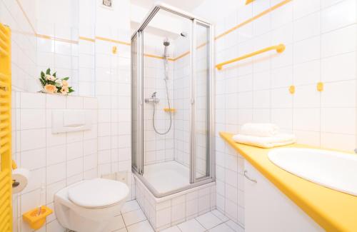 W łazience znajduje się prysznic, toaleta i umywalka. w obiekcie Haus-Frisia-Appartement-402 w mieście Sankt Peter-Ording