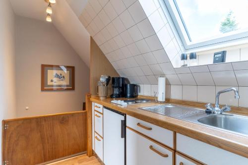 a kitchen with a sink and a skylight at Ferienwohnung-Elli in Garding