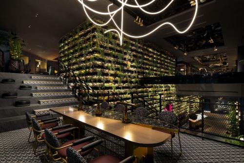 a restaurant with a wall of wine bottles at Mercure Tokyu Stay Osaka Namba in Osaka