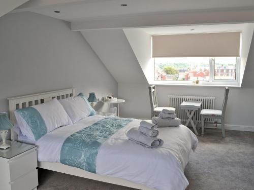 a bedroom with a bed with towels on it at Abbeydale Town House in Whitby