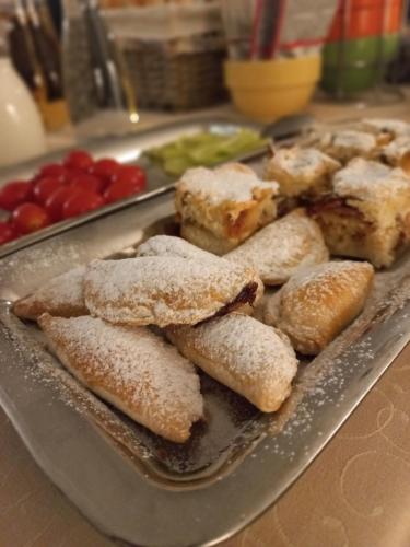 a tray filled with pastries on top of a table at Hotel Bílá Paní in Jindrichuv Hradec
