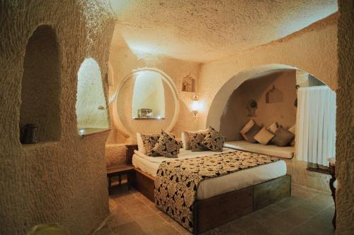 a bedroom with a bed in a room with an archway at Hu of Cappadocia - Special Class in Uchisar