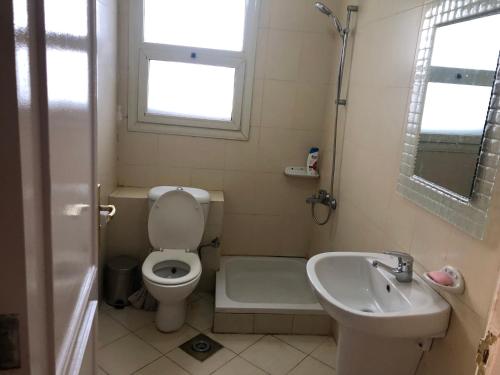 a small bathroom with a toilet and a sink at Tow bedroom flat at Muntazah Sharm Elshikh in Sharm El Sheikh