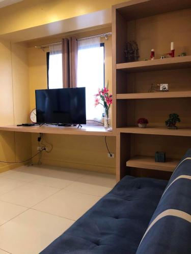 a room with a desk with a television and a window at Camella Northpoint in Davao City