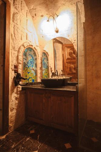 a bathroom with a sink and a mirror at Hu of Cappadocia - Special Class in Uchisar