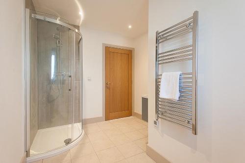 a bathroom with a shower and a glass shower stall at The Dairy in Cricklade