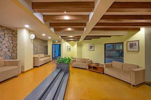 a lobby with couches and a table in a building at Sterling Yercaud in Yercaud