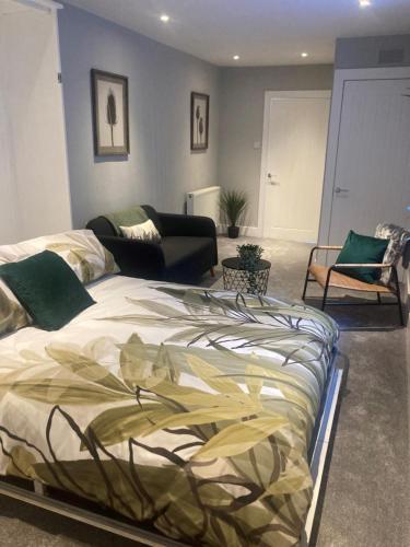 a bedroom with a bed and a living room at Teviot View Apartment in Hawick