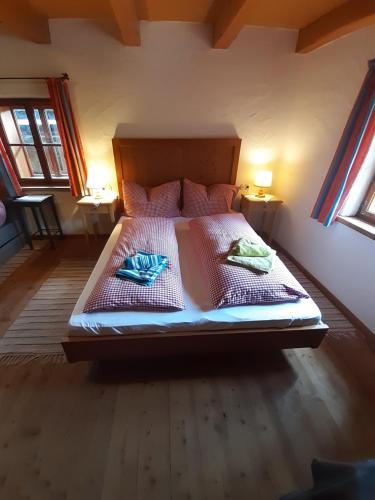 a bedroom with a bed with two towels on it at Sonnleit'n Zimmer 6 in Abtenau