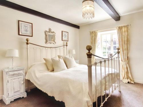 a bedroom with a white bed and a window at Carriage House - E5119 in West Burton