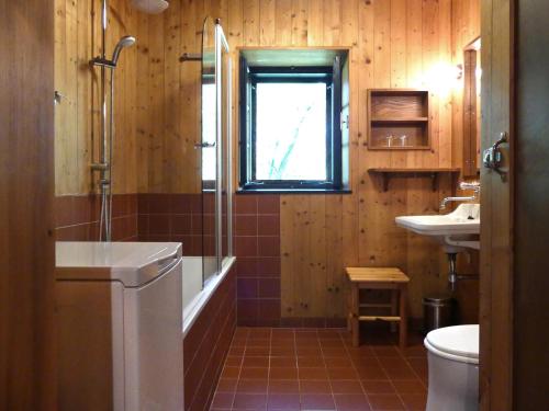 a bathroom with a tub and a sink and a window at Haus Eveline in Gerersdorf bei Güssing