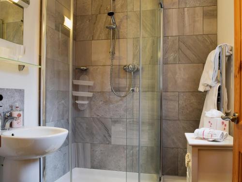 a bathroom with a shower and a sink at The Coach House in Great Malvern