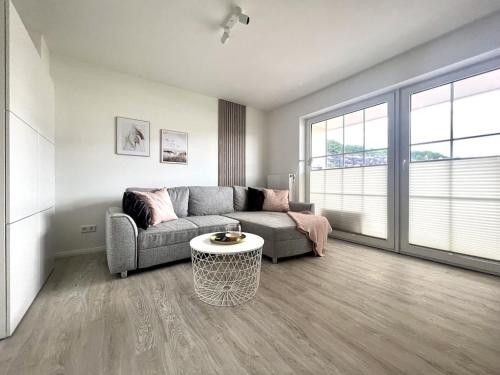 a living room with a couch and a table at `Kapitänslounge` vollsanierte Fewo mit Blick auf die Flensburger Förde in Harrislee