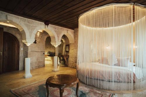 a bedroom with a bed and a table in a room at Hu of Cappadocia - Special Class in Uchisar