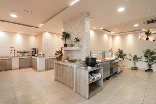 a large kitchen with a sink and a counter at Karras Hotel in Laganas