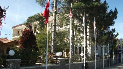 a house with flags in front of it at Hotel Aşıkoğlu in Bogazkale