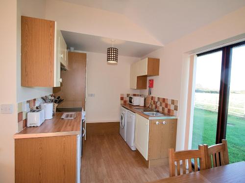a kitchen with a sink and a dishwasher at Russet Cottage - E4678 in Brean