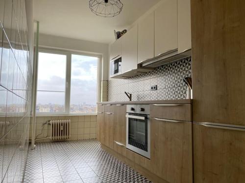 a kitchen with a stove and a large window at 2 bedroom appartement in Antwerp, with amazing view in Antwerp