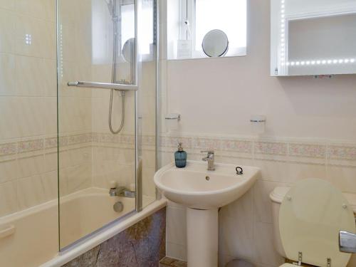 een badkamer met een wastafel, een toilet en een douche bij Signals Court in Scarborough