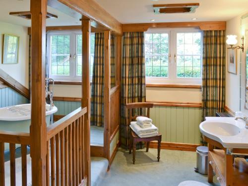 a bathroom with a staircase and a sink at Dove Cote House in Westleigh