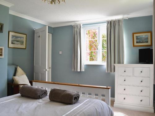 a bedroom with a bed with two pillows on it at The Garden Cottage in Wrafton