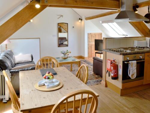 a kitchen and living room with a table and chairs at The Granary - Hkkw in Lynton