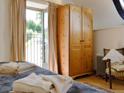 a bedroom with a bed and a large window at The Granary - Hkkw in Lynton