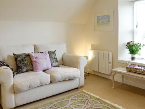 a living room with a couch and a table at Kerloch View in Banchory